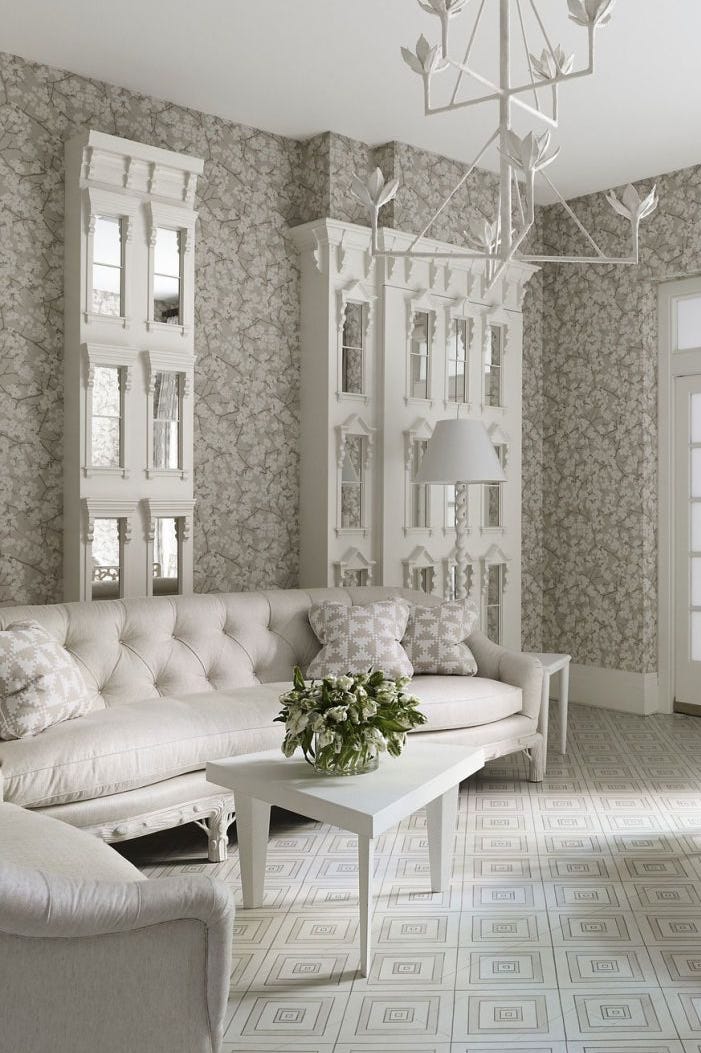 Finished wallpapered living room with a warm patterned feature wall